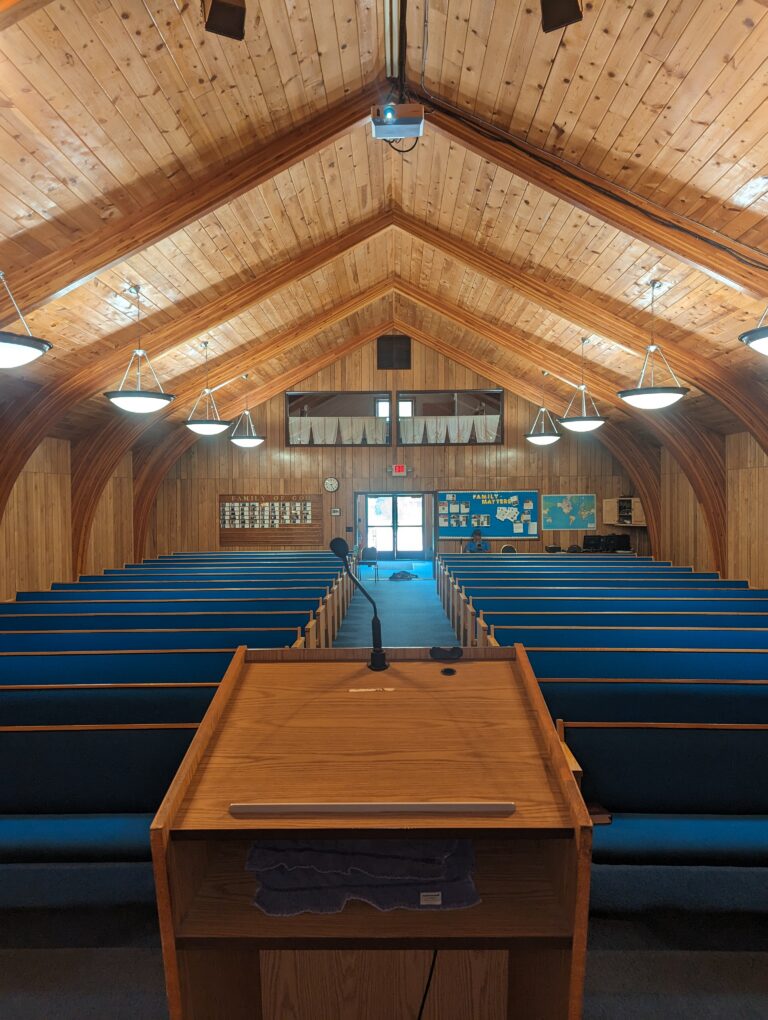 Wooden church interior with pews of Gillette COC